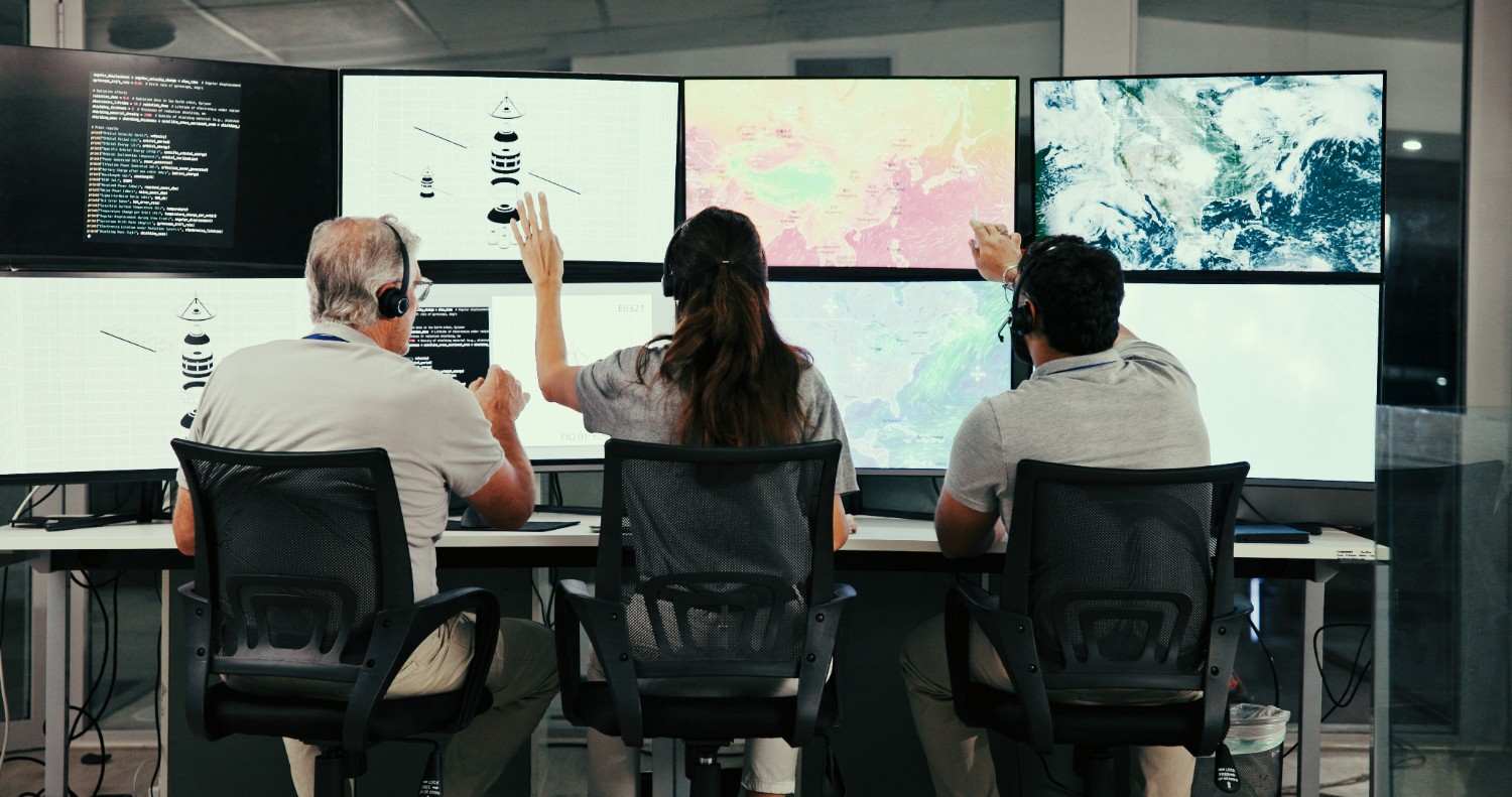 Operators monitoring complex telemetry and operations data in command room